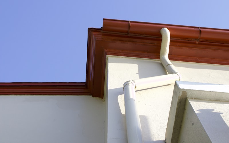 Cleanly installed aluminum gutters along residential roofline