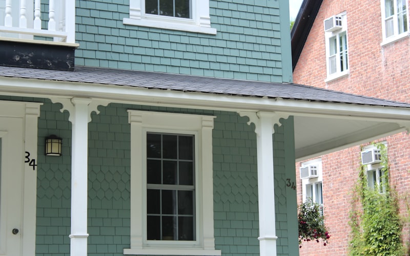 Home with decorative shingle siding and white trim details